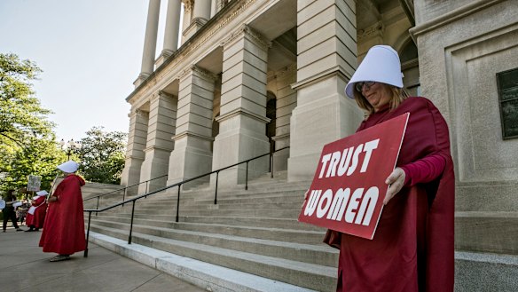 Michelle Disher and others dressed as characters from The Handmaid's Tale protest outside the Georgia Capitol.