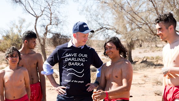 NSW Environment Minister, Matt Matt Kean (in blue shirt), meets dancers in the newly expanded Mutawintji national park during a visit in September 2019.