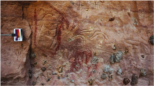 Rock carvings and paintings at the Marra Wonga site, including boomerangs and a penis outlined in red ochre.