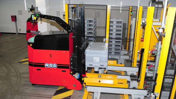 An automatic forklift prepares to take a box of money to the distribution area.