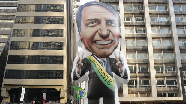 Supporters of Jair Bolsonaro, presidential candidate for the National Social Liberal Party who was stabbed during a campaign event, exhibit a large, inflatable doll in his image to show support for him, in Sao Paulo, Brazil.