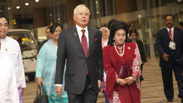 Malaysia’s then-PM Najib Razak walks alongside his wife Rosmah Mansor in 2014.