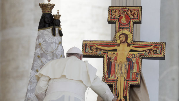 Pope Francis blesses a statue of the Virgin Mary and a crucifix that will be taken to Panama for the next World Youth Day, in St. Peter's Square on Sunday.