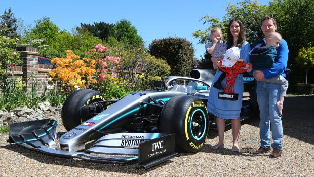 Harry Shaw, 5, who has been diagnosed with a rare form of bone cancer, is carried by father James with mother Charlotte and sister Georgia and a replica of Lewis Hamilton's Formula 1 car.