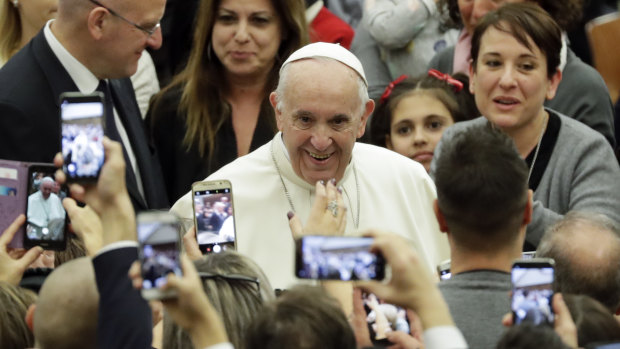 Pope Francis arrives for an audience with Vatican employees, in the Pope Paul VI hall, at the Vatican.