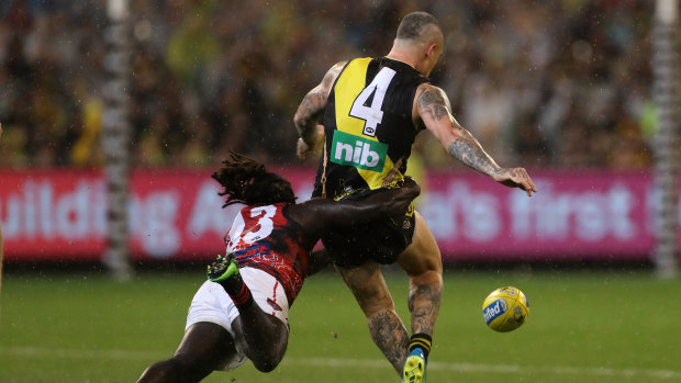 He's comin' to getcha: Anthony McDonald-Tipungwuti lays a rundown tackle on Dustin Martin.