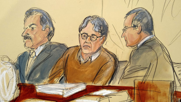 Keith Raniere seated between his attorneys Paul DerOhannesian, left, and Marc Agnifilo during the first day of his sex trafficking trial.