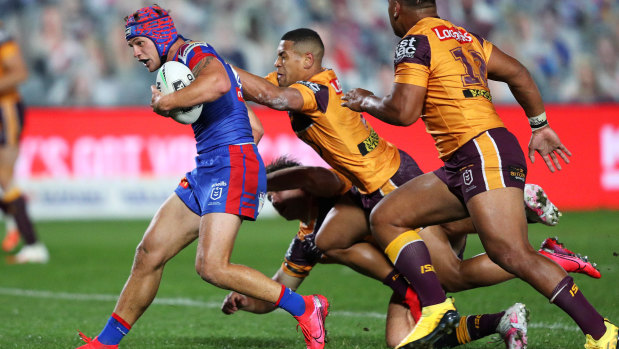 Kalyn Ponga is dragged down before Jamayne Isaako went to the sin bin in the first half.