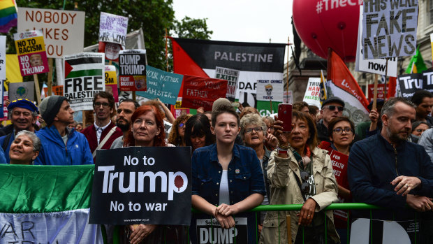 Protesters gather listen to Opposition Leader Jeremy Corbyn at an anti-Trump rally in London on Tuesday.