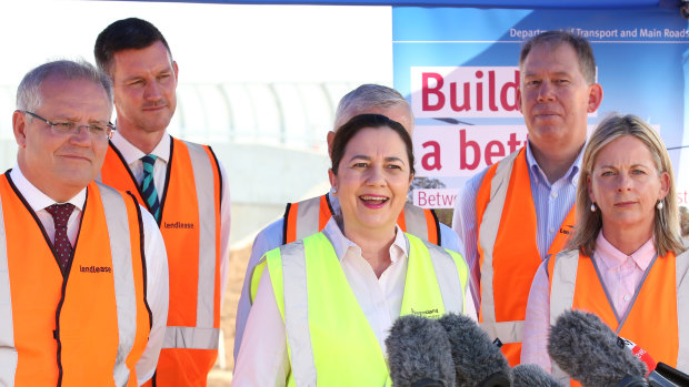 Left to right (front): Prime Minister Scott Morrison, Queensland Premier Annastacia Palaszczuk and Member for Moncrieff Angie Bell, at a construction site in Brisbane, where new infrastructure funding was announced in 2019.