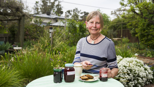 Angelika Dunker enjoying crackers and home made jam in her garden.