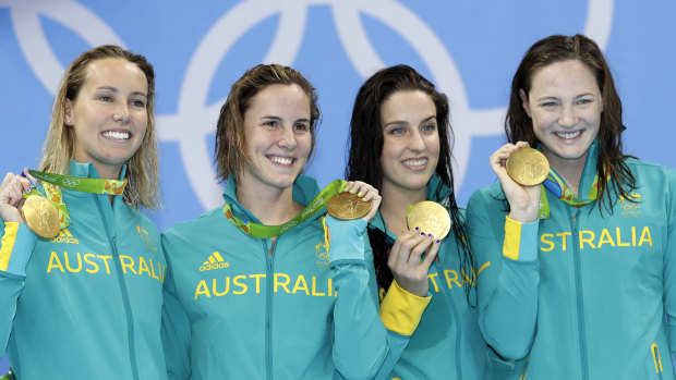 Golden girls ... Australia’s Emma McKeon, left, Bronte Campbell, second left, Brittany Elmslie, second right, and Cate Campbell, right, show off their gold medals during the ceremony for the women’s 4x100-metre freestyle at the 2016 Olympics.