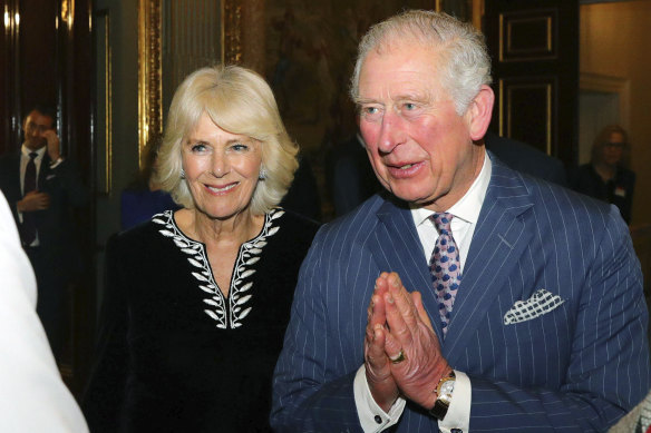 Prince Charles using the "namaste" greeting.