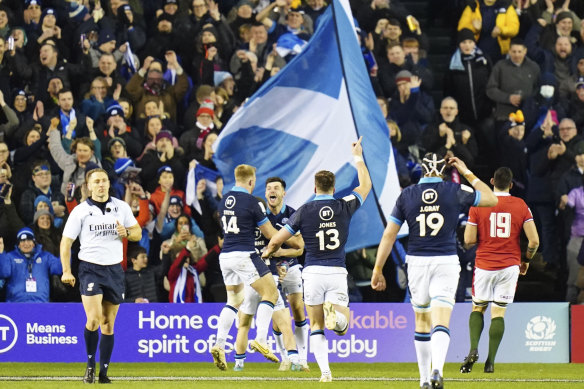 Scotland’s Blair Kinghorn, centre, celebrates scoring a try.