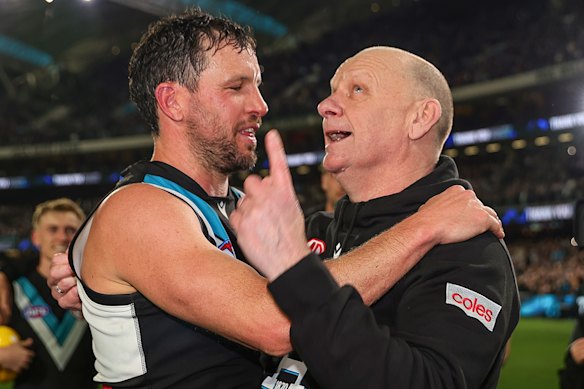 Travis Boak with Ken Hinkley as he gestures to the sky towards Boak’s father.