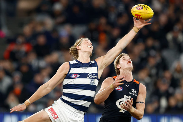 Sam De Koning, for Geelong, beats brother Tom, of Carlton, to the ball at the MCG on Friday night.