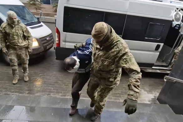 A suspect in the Crocus City Hall shooting on Friday is escorted to the Russian Investigative Committee headquarters in Moscow, Russia. 