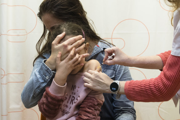 Children five and up are already receiving Pfizer’s two-dose coronavirus vaccine in many countries, including Israel. Pictured: Almog Taub, 6, sitting on her mother’s knee as she gets her jab in Netanya, Israel. 