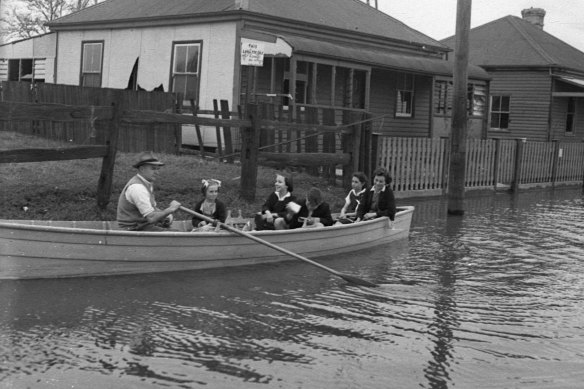 All aboard: children excavated in Maitland floods, 1950.