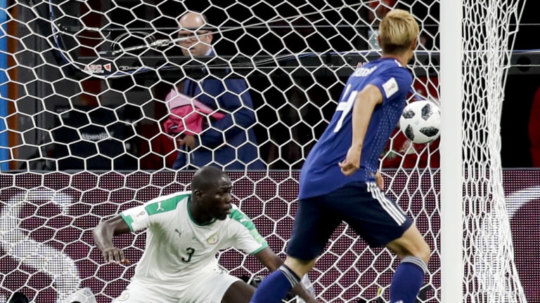 Japan's Keisuke Honda scores against Senegal in this year's World Cup.