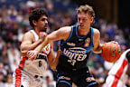 Luke Travers of Melbourne United drives at the basket.