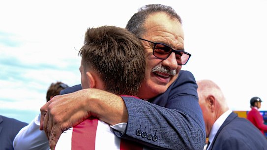 Trainer John Sargent embraces Dylan Gibbons.
