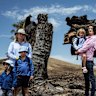 Annabelle Cleeland and her five-year-old daughter Quinn (c) with Lou Webb (l) and her children Tom and Fred, 3, and George, 6, and Felicity Jeffrey and her children Jemima,6, Sebastien,4 and Claudio,1, stand in the burnt out Jeffrey property in Whiteheads Creek. All three families homes were decimated by the Longwood fire in early January and now the kids are looking to head back to school. A number of schools and kindergartens in the Seymour area are either closed, have had delayed starts impacted by the bushfires.