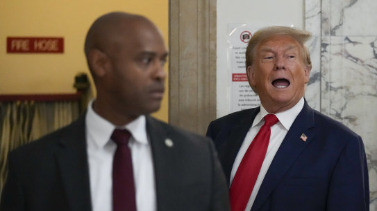 Former president Donald Trump stops to speak to the media during a break in his civil business fraud trial at New York Supreme Court.