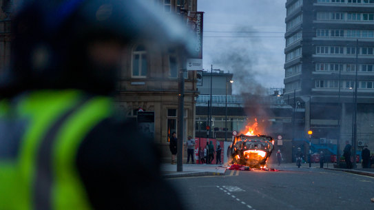 A police car is set on fire as far-right activists rally in Sunderland, England. 