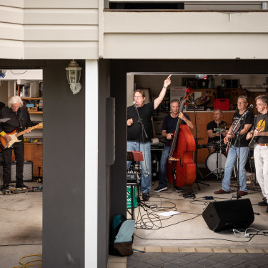 Highly Strung, which includes the writer’s husband, David Fagan (at far right), rehearses in a Brisbane garage. Band member Kenn McCall (second from right) says it’s like joining a sporting team.