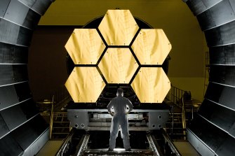 NASA engineer Ernie Wright looks on as the first flight-ready mirror segments are prepped to begin final cryogenic testing at NASA’s Marshall Space Flight Centre this year in prepartion for the James Webb Space Telescope’s launch, now scheduled for Christmas Day.
