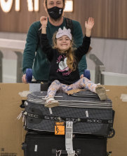 Vicky Yegen and Shayne Ryan arrive at Melbourne Airport on Monday with their children William and Talia.