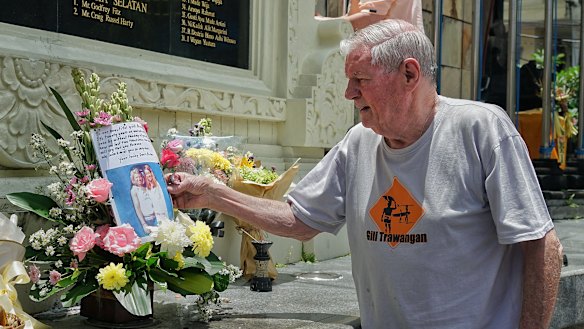 Danny Hanley leaves a photo of his daughters and a note at the Bali memorial on Tuesday.