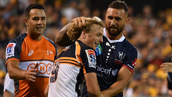 Niggle and giggle: Quade Cooper lets Joe Powell know he's back in Super Rugby.