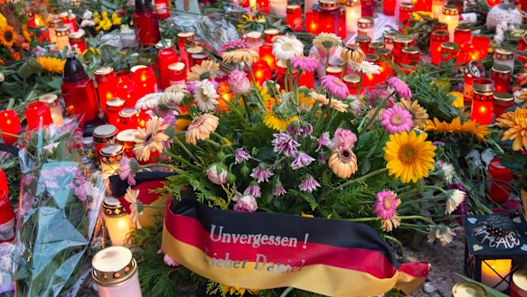 Flowers, candles and a flag saying "Unforgotten, Dear Daniel" sit at the scene of an altercation in Chemnitz, Germany, where a 35-year-old German of Cuban descent man was killed in an altercation with migrants.