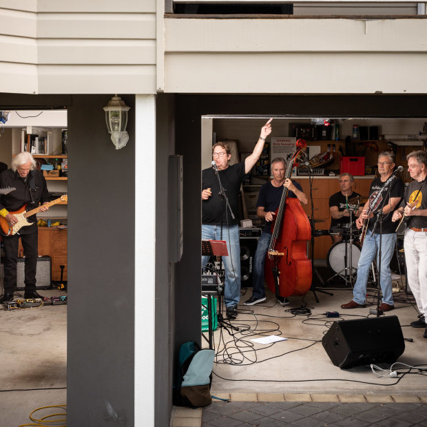 Highly Strung, which includes the writer’s husband, David Fagan (at far right), rehearses in a Brisbane garage. Band member Kenn McCall (second from right) says it’s like joining a sporting team.