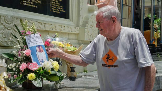 Danny Hanley leaves a photo of his daughters and a note at the Bali memorial on Tuesday.