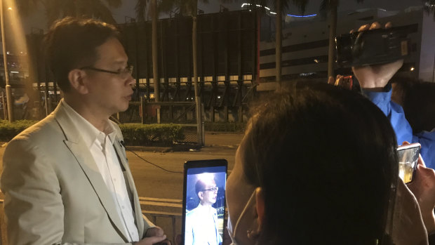 Ip Kin Yuen talks to distressed parents outside Polytechnic University cordon Tuesday evening.