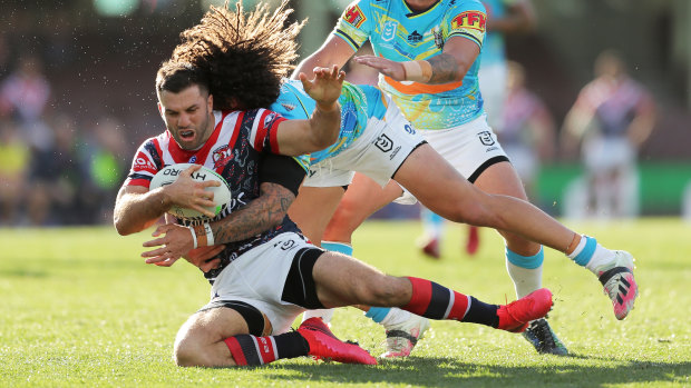 Tedesco is tackled by Kevin Proctor during the Roosters' win over the Titans.