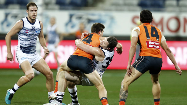 Toby Greene tries to fend off Patrick Dangerfield.