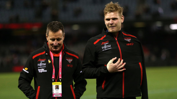 Sidelined: Injured defender Michael Hurley with Bombers coach John Worsfold.