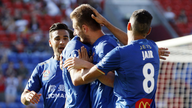 New blood: The Jets mob Kaine Sheppard after he capped a stunning rise with a goal against the Roar: