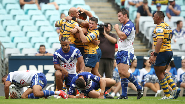 Too hot to handle: Parramatta celebrate Blake Ferguson's try in Sunday's win over the Bulldogs.