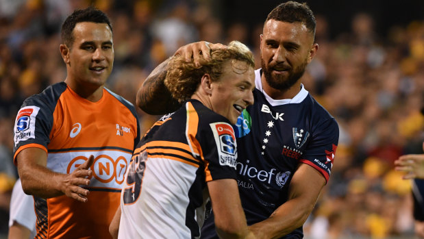 Niggle and giggle: Quade Cooper lets Joe Powell know he's back in Super Rugby.