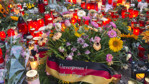 Flowers, candles and a flag saying "Unforgotten, Dear Daniel" sit at the scene of an altercation in Chemnitz, Germany, where a 35-year-old German of Cuban descent man was killed in an altercation with migrants.