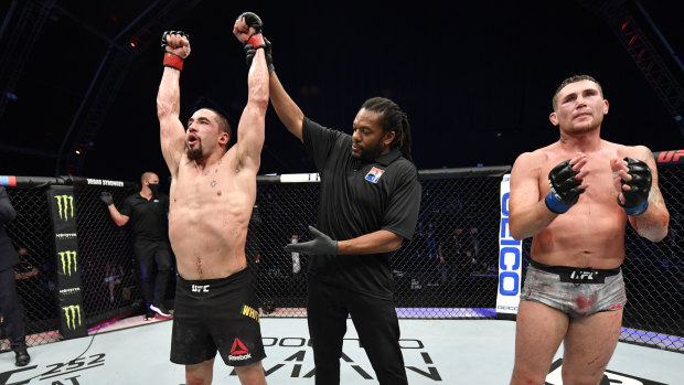 Going the distance: Robert Whittaker celebrates his win.