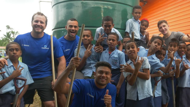 Making a difference: Clint Newton, Victor Radley, Jayson Bukuya and David Nofoaluma with friends in Fiji. 