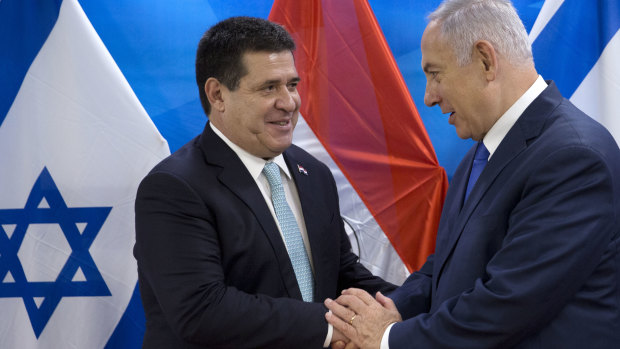 Israeli Prime Minister Benjamin Netanyahu, right, shakes hands with then Paraguayan president Horacio Cartes in Jerusalem in May.