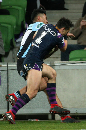 Trouble? Billy Slater collects Sosaia Feki.