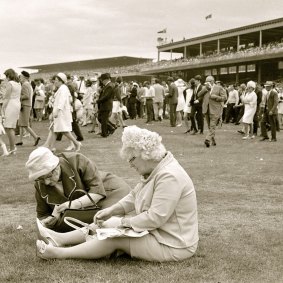 Two punters check for a winning ticket at the 1968 Melbourne Cup.